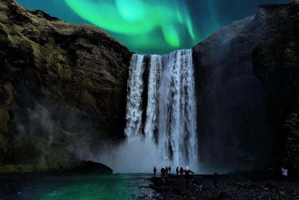 50th birthday trip ideas: Iceland. Northern Lights behind a waterfall
